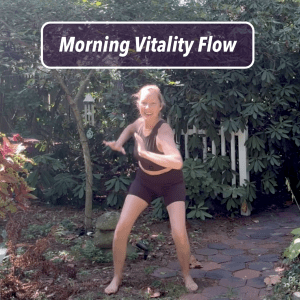 Melissa leading Morning Vitality Flow outdoors, smiling and moving with energy in a grounded stance.