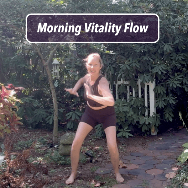 Melissa leading Morning Vitality Flow outdoors, smiling and moving with energy in a grounded stance.